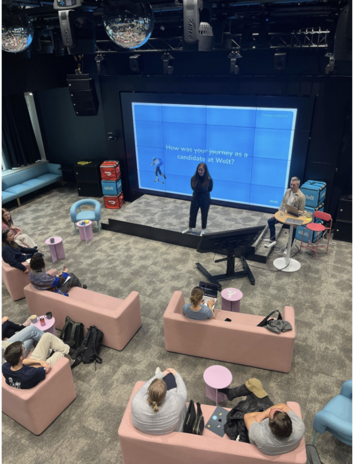 Speaker on stage at a Wolt candidate experience session